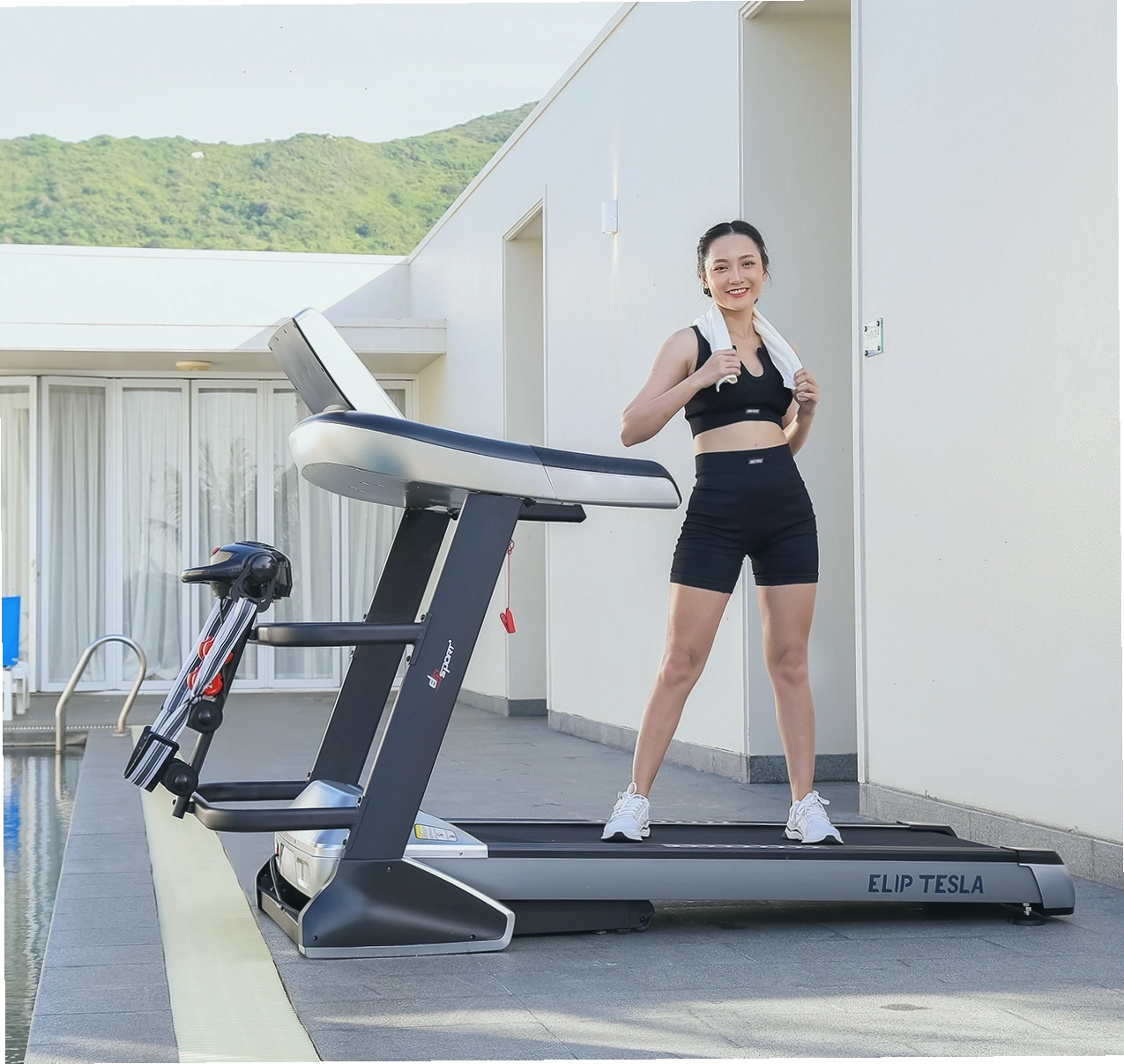 Người phụ nữ tập luyện trên máy chạy bộ tại nhà